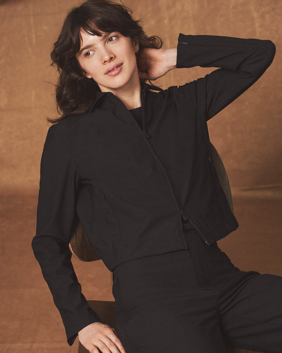 Women wearing a black Dockers® Go overshirt with a Dockers® logo on a brown background