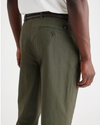 View of model wearing Army Green Men's Relaxed Taper Fit Original Pleated Chino Pants.
