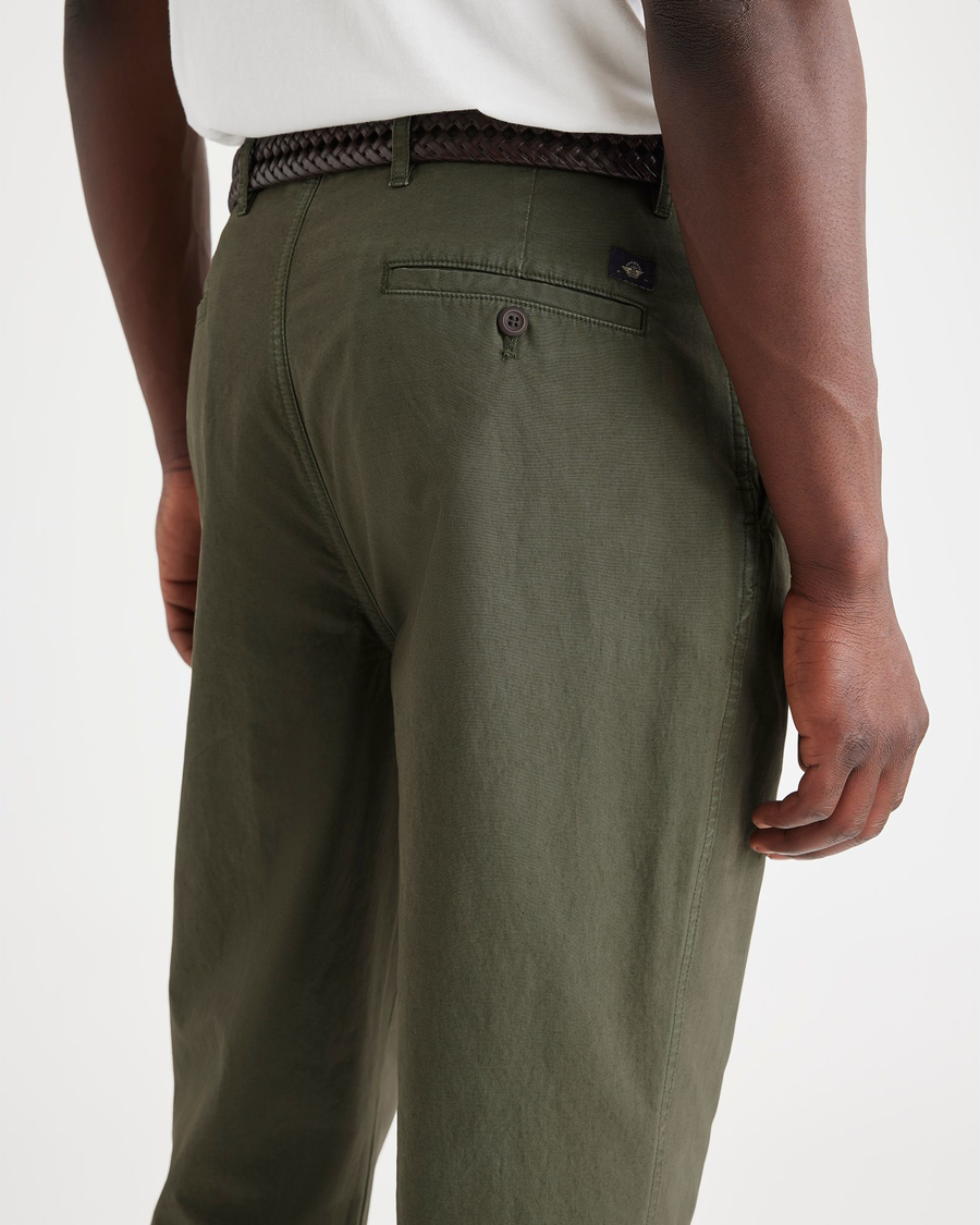 View of model wearing Army Green Men's Relaxed Taper Fit Original Pleated Chino Pants.