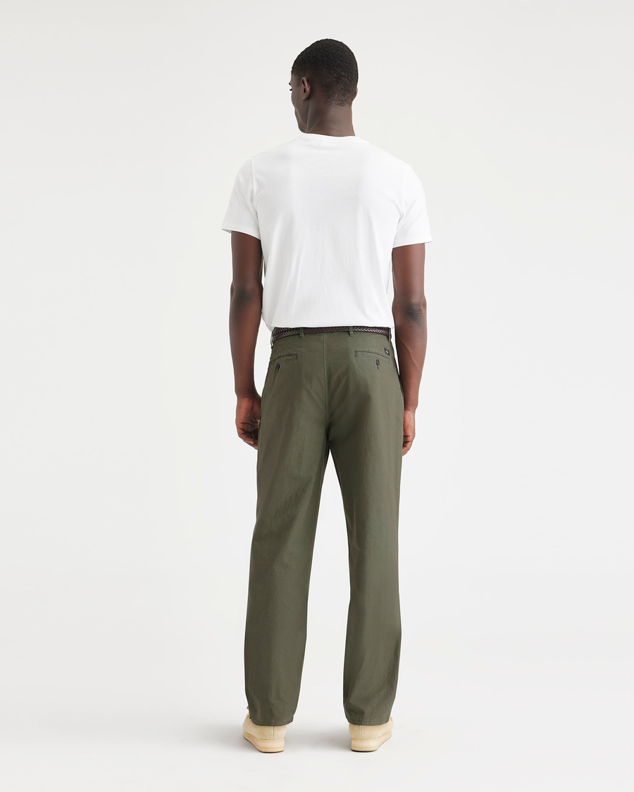 Back view of model wearing Army Green Men's Relaxed Taper Fit Original Pleated Chino Pants.