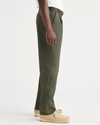Side view of model wearing Army Green Men's Relaxed Taper Fit Original Pleated Chino Pants.