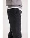 Side view of model wearing Asphalt Men's Slim Fit Smart 360 Flex Alpha Chino Pants.