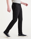 Side view of model wearing Beautiful Black Alpha Chino Pants, Skinny Fit.