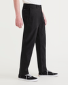 Side view of model wearing Beautiful Black Alpha Chino Pants, Slim Fit.