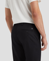 View of model wearing Beautiful Black Signature Iron Free Khakis, Slim Fit with Stain Defender®.