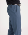 Side view of model wearing Bluefin Men's Slim Fit Smart 360 Flex Alpha Chino Pants.