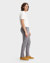 Side view of model wearing Burma Grey Men's Slim Fit Smart 360 Flex Alpha Khaki Pants.
