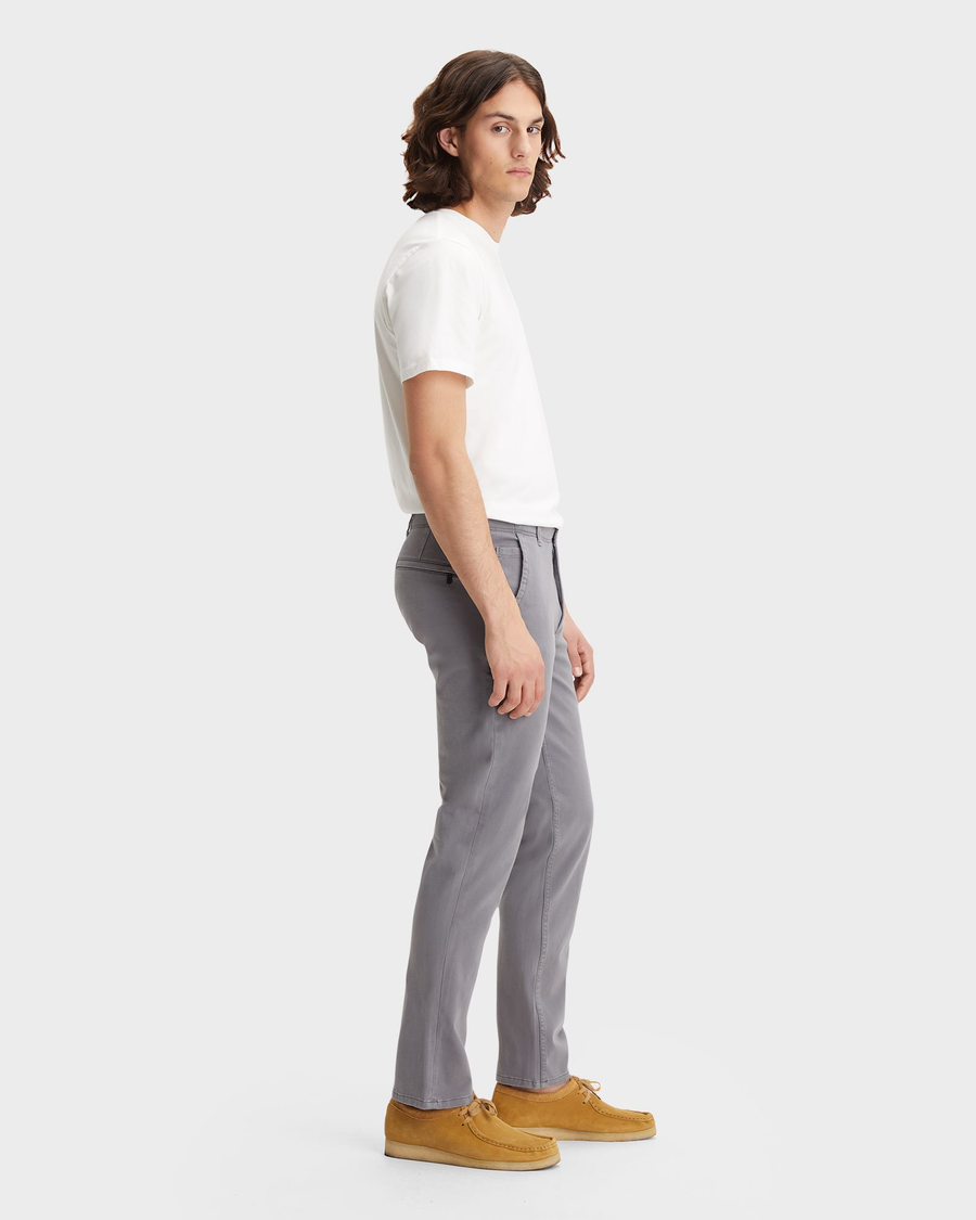 Side view of model wearing Burma Grey Men's Slim Fit Smart 360 Flex Alpha Khaki Pants.