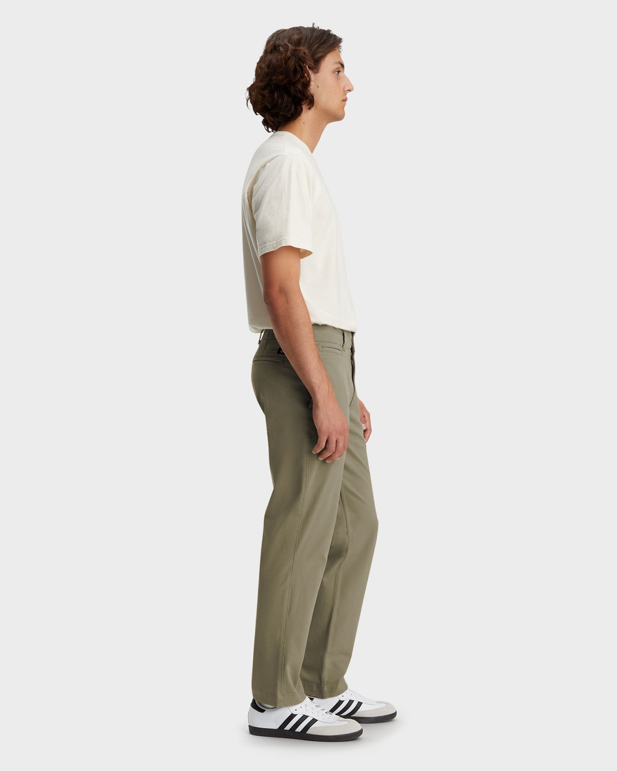 Side view of model wearing Camo Men's Straight Fit Smart 360 Flex California Chino Pants.