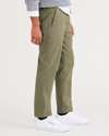 Side view of model wearing Camo Men's Straight Tapered Fit California Pull-On Pants.