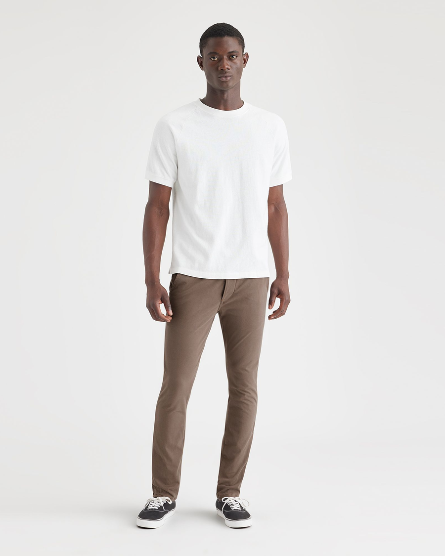 Front view of model wearing Coffee Quartz Men's Skinny Fit Supreme Flex Alpha Khaki Pants.