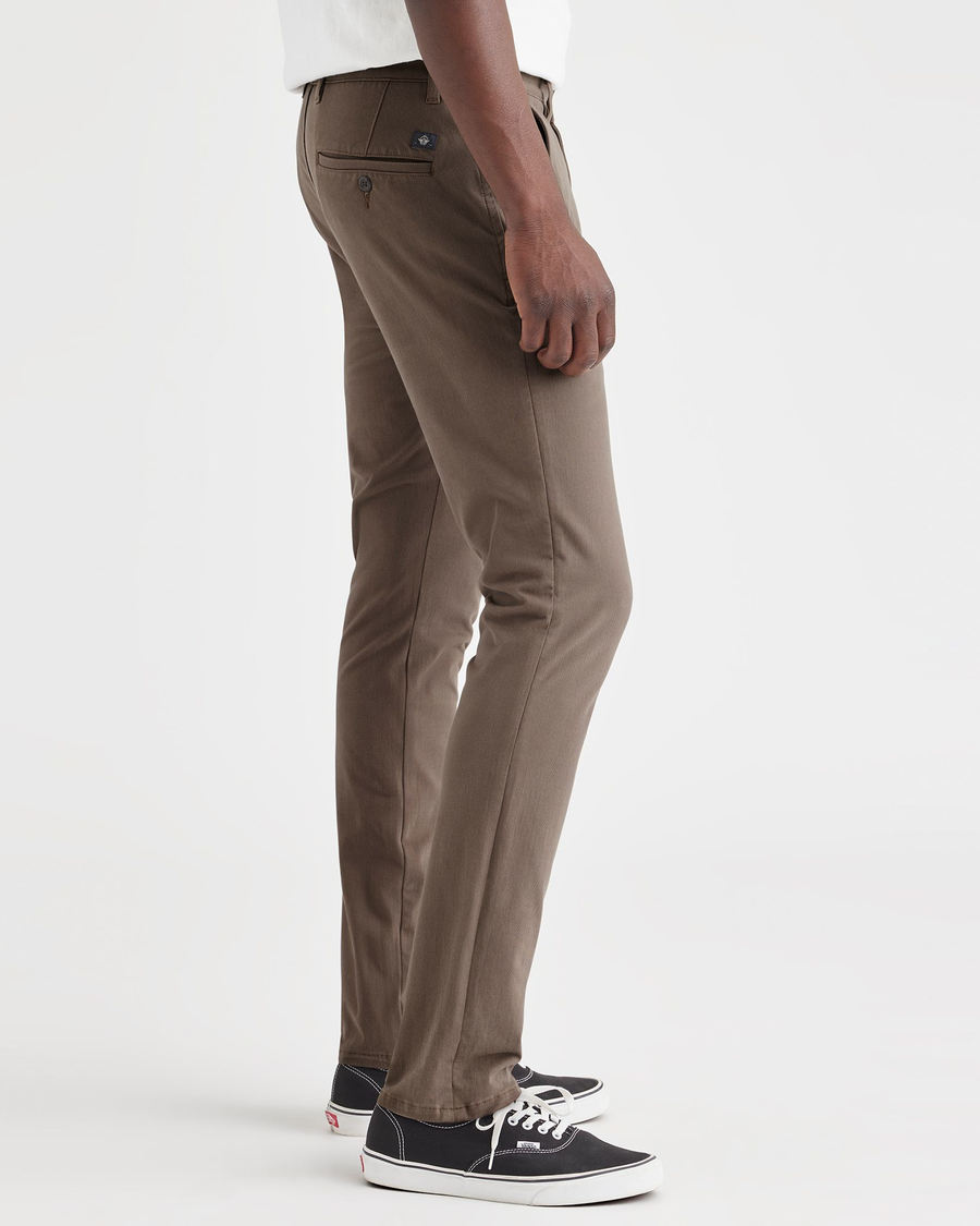 Side view of model wearing Coffee Quartz Men's Skinny Fit Supreme Flex Alpha Khaki Pants.