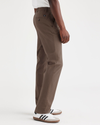 Side view of model wearing Coffee Quartz Men's Slim Fit Smart 360 Flex Alpha Chino Pants.