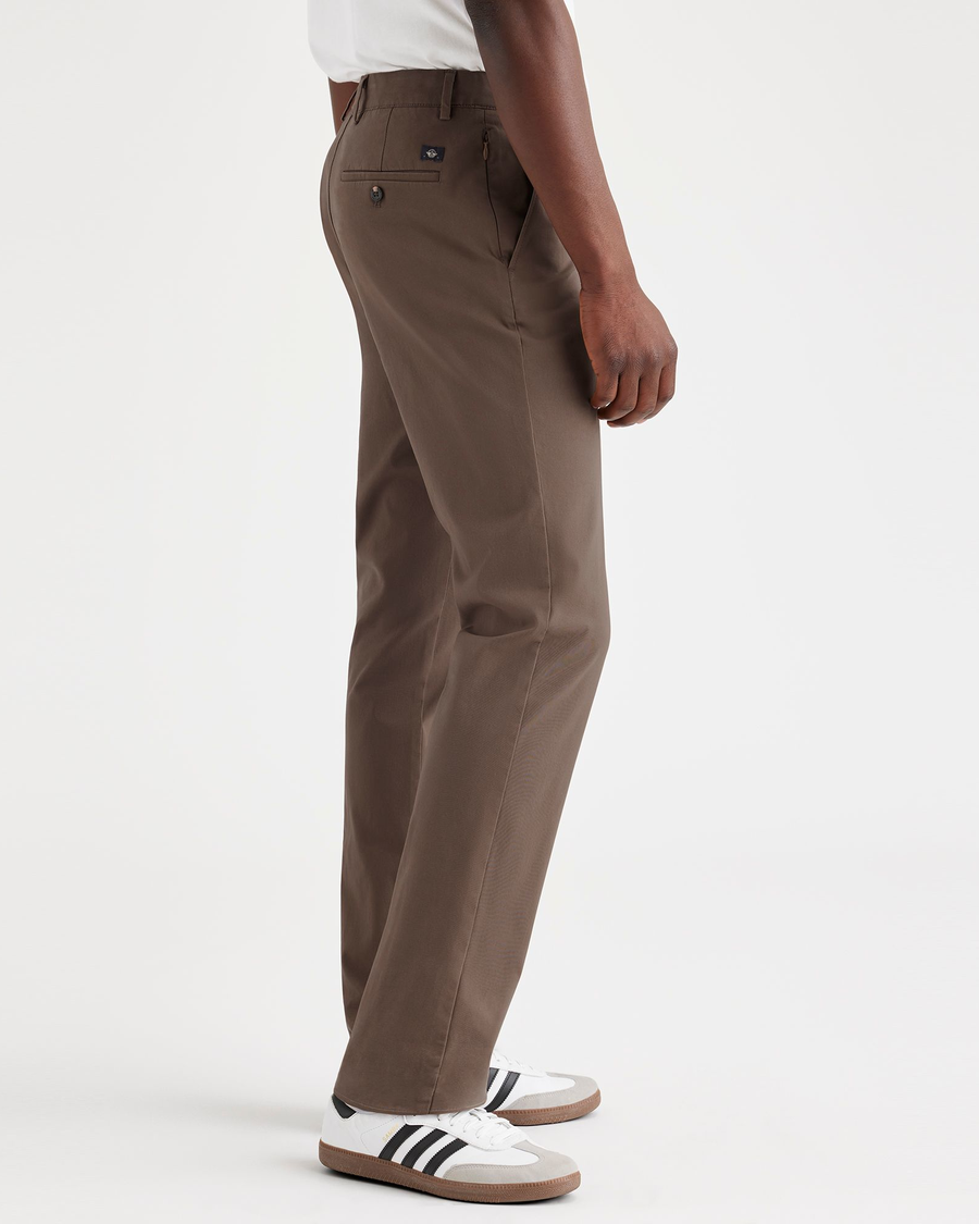 Side view of model wearing Coffee Quartz Men's Slim Fit Smart 360 Flex Alpha Chino Pants.