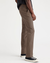 Side view of model wearing Coffee Quartz Men's Slim Fit Smart 360 Flex California Chino Pants.