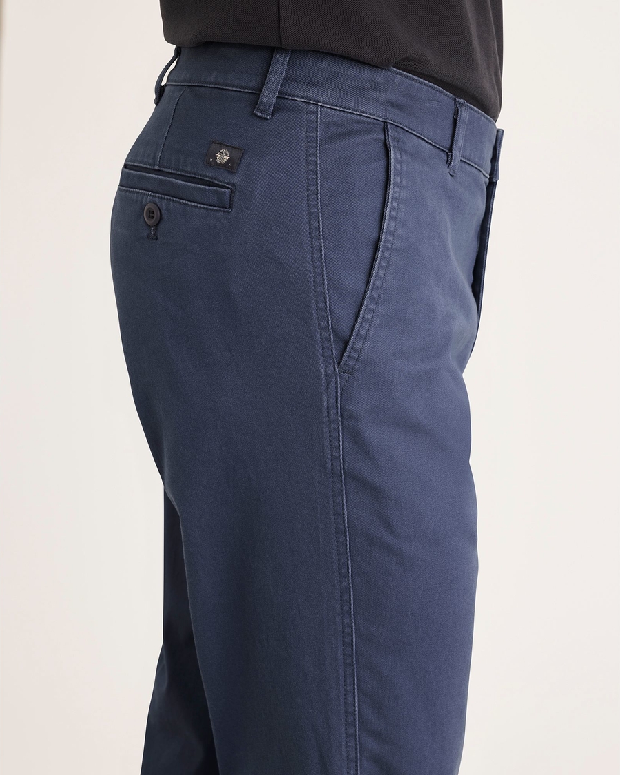 Side view of model wearing Crown Blue Men's Slim Fit Original Chino Pants.