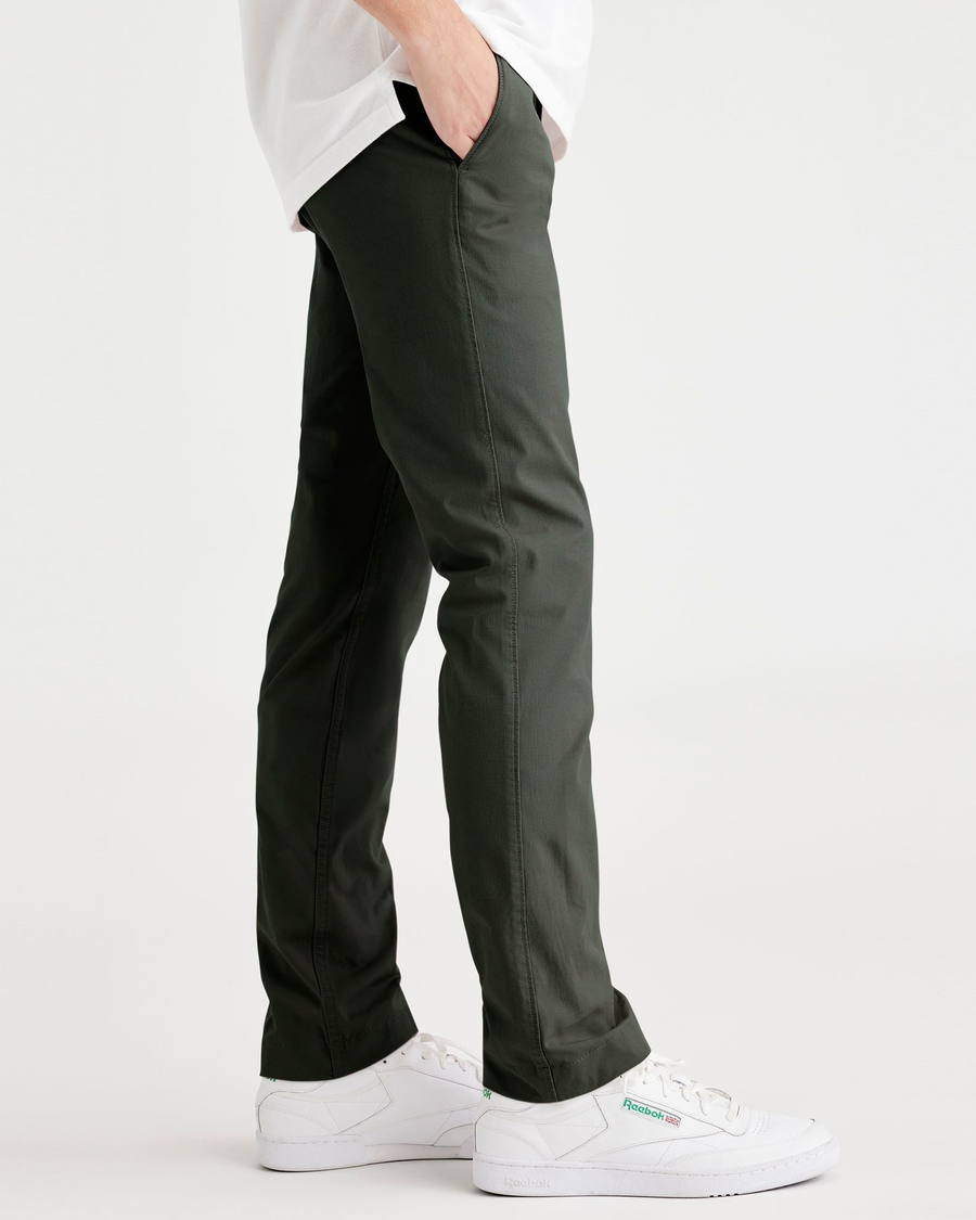 Side view of model wearing Deep Forest Men's Skinny Fit Smart 360 Flex California Chino Pants.