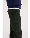 Side view of model wearing Deep Forest Men's Slim Tapered Fit Cargo Pants.