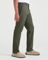 Side view of model wearing Dockers Olive Men's Slim Fit Smart 360 Flex Alpha Chino Pants.