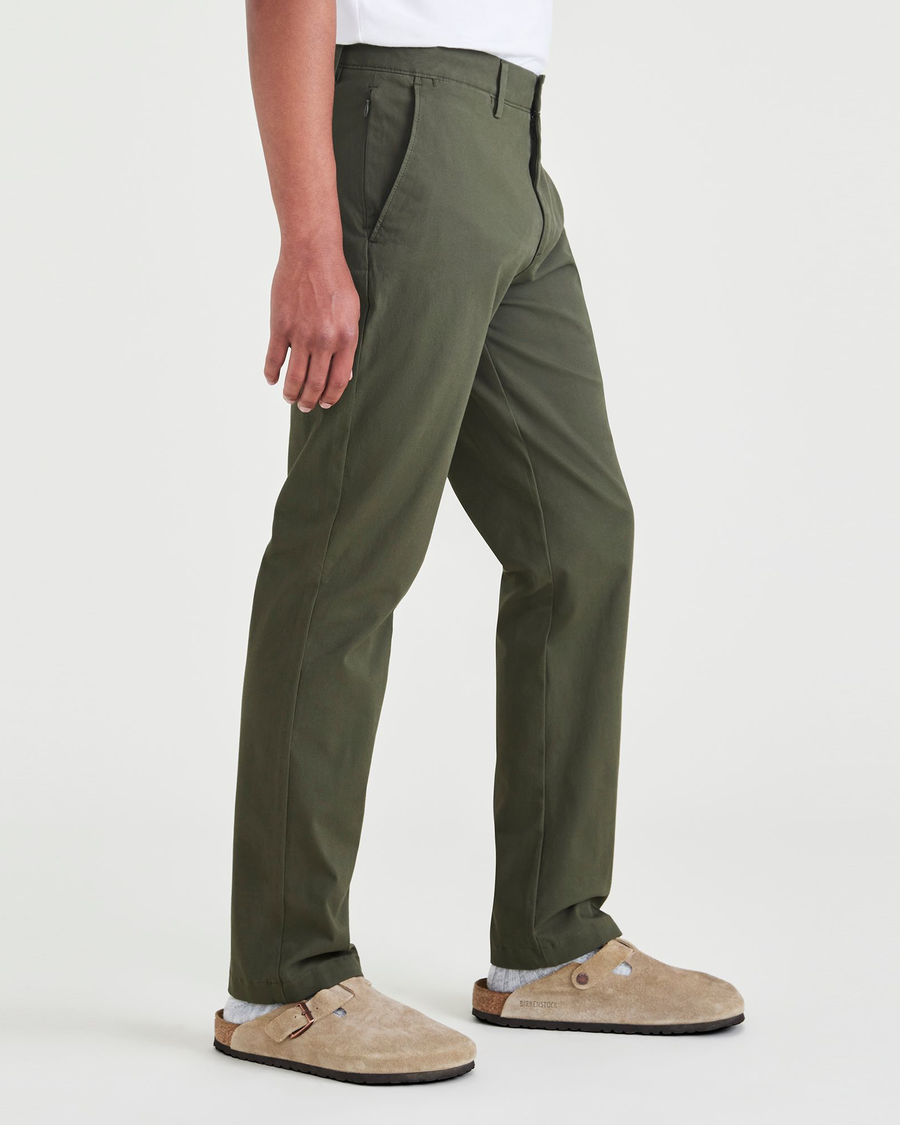 Side view of model wearing Dockers Olive Men's Slim Fit Smart 360 Flex Alpha Chino Pants.