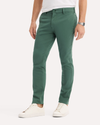 Side view of model wearing Duck Green Go Activeflex Chino, Skinny Fit.