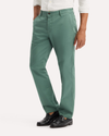 Side view of model wearing Duck Green Original Chino Pants, Slim Fit.