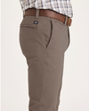 Side view of model wearing Fossil Men's Skinny Fit Smart 360 Flex California Chino Pants.