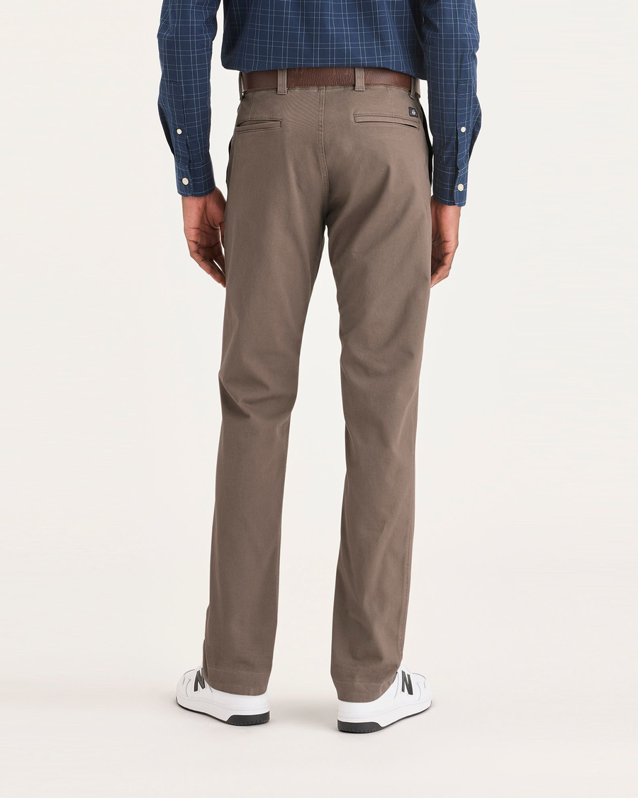 Back view of model wearing Fossil Men's Slim Fit Smart 360 Flex California Chino Pants.