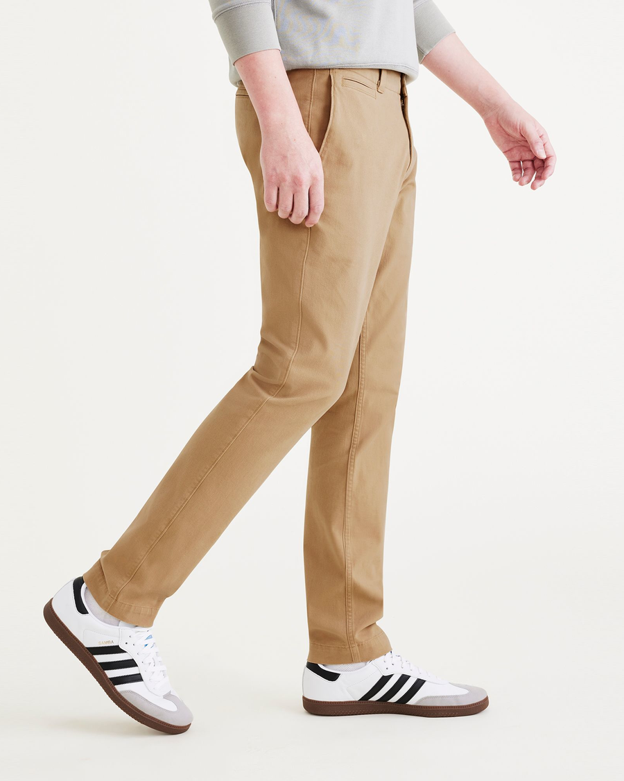 Side view of model wearing Harvest Gold Alpha Chino Pants, Skinny Fit.