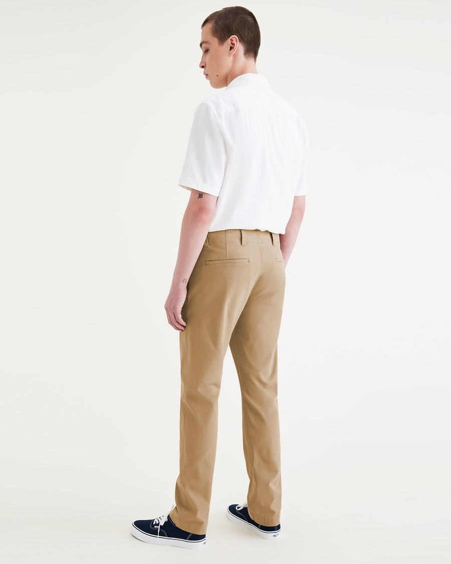 Back view of model wearing Harvest Gold Men's Slim Fit Smart 360 Flex California Chino Pants.