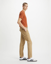Side view of model wearing Harvest Gold Men's Slim Tapered Fit Cargo Pants.