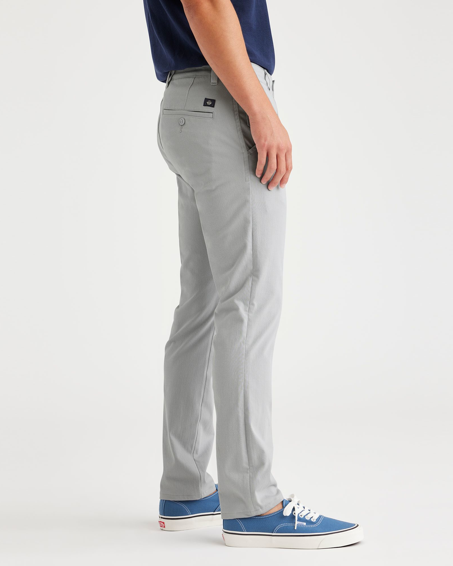 Side view of model wearing High-Rise Men's Skinny Fit Supreme Flex Alpha Khaki Pants.