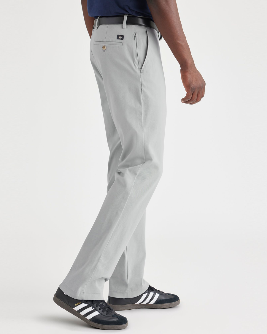 Side view of model wearing High-Rise Men's Slim Fit Smart 360 Flex Alpha Chino Pants.