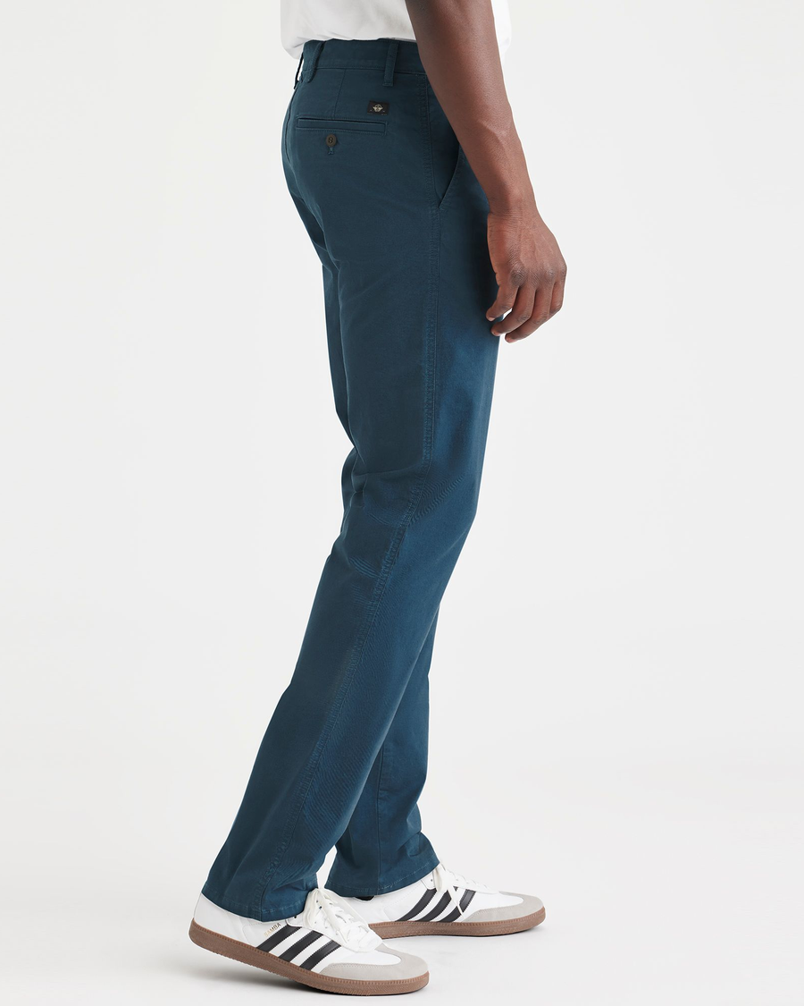 Side view of model wearing Indian Teal Men's Slim Fit Original Chino Pants.