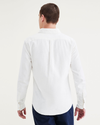 Back view of model wearing Light White Rigid Men's Slim Fit Icon Button Up Shirt.
