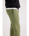 Side view of model wearing Loden Green Men's Skinny Fit Smart 360 Flex California Chino Pants.