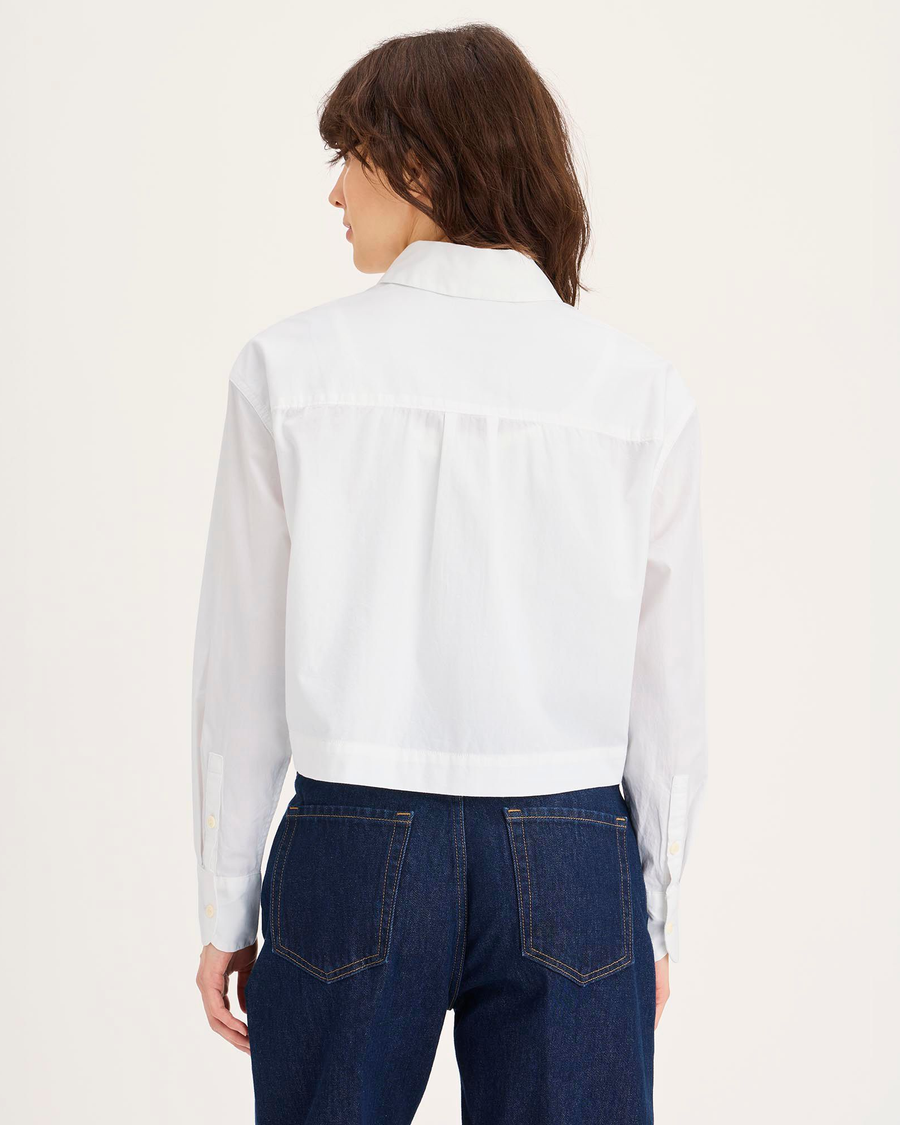 Back view of model wearing Lucent White Boxy Cropped Shirt, Relaxed Fit.