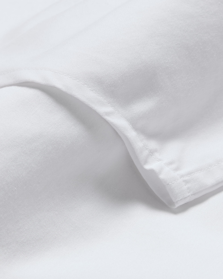 View of model wearing Lucent White Signature Shirt with Stain Defender®, Slim Fit.