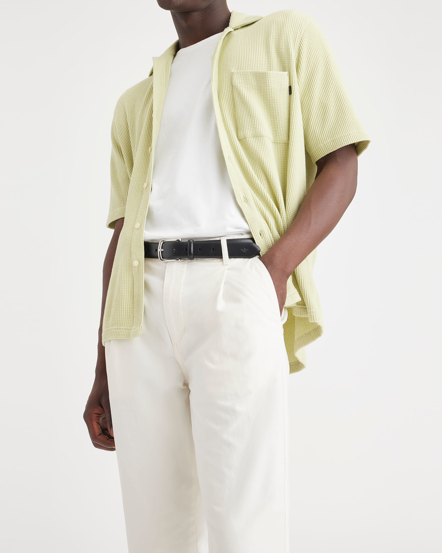 View of model wearing Natural Men's Relaxed Taper Fit Original Pleated Chino Pants.