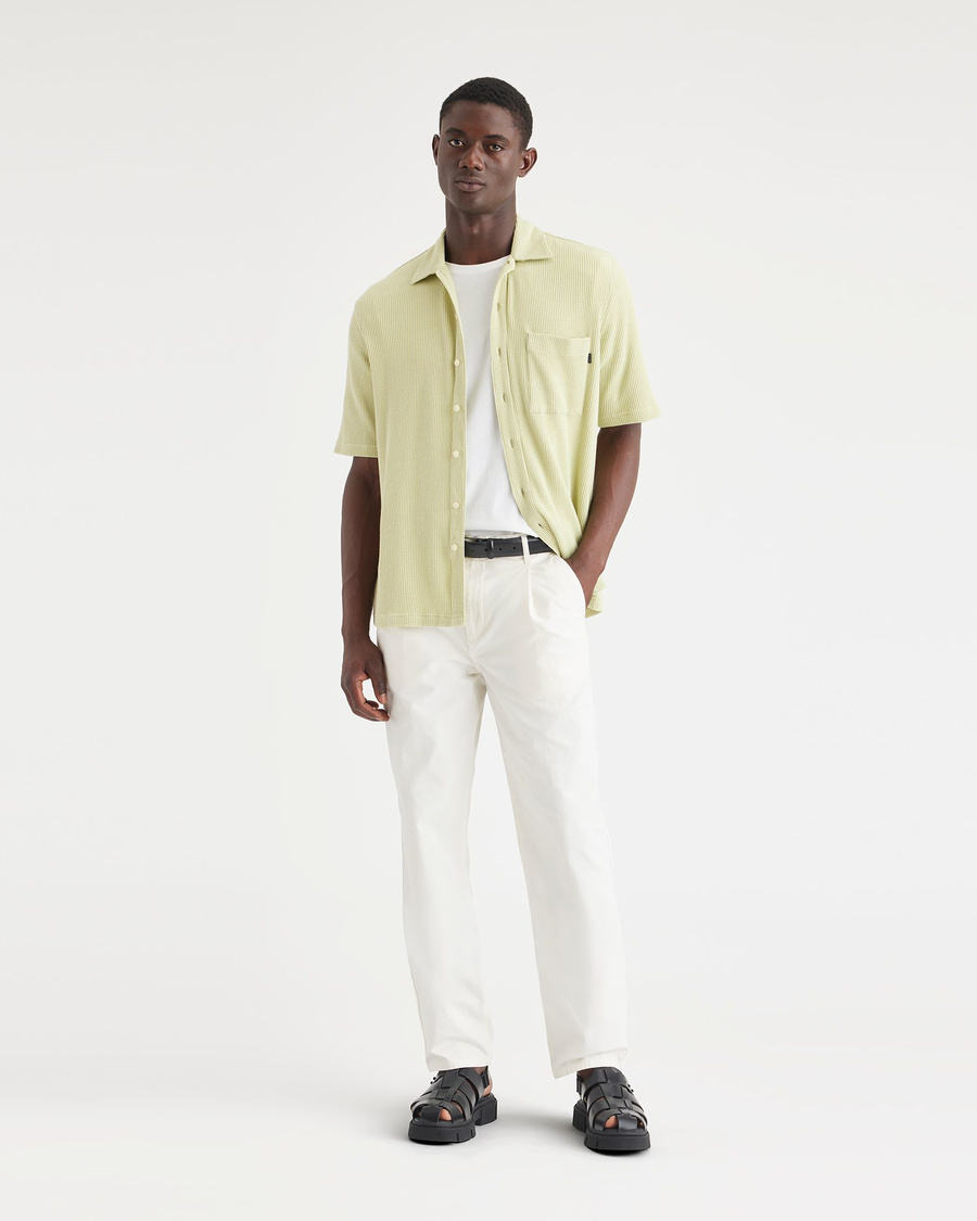 Front view of model wearing Natural Men's Relaxed Taper Fit Original Pleated Chino Pants.