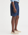 Side view of model wearing Navy Blazer Men's Classic Fit Original Pleated Shorts.