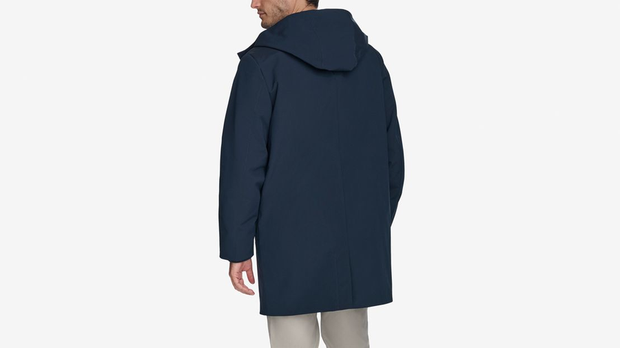 Back view of model wearing Navy Blazer Men's Performance Welded Modern Parka Jacket.