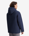 Back view of model wearing Navy Blazer Men's Poly Arctic Hooded Jacket.