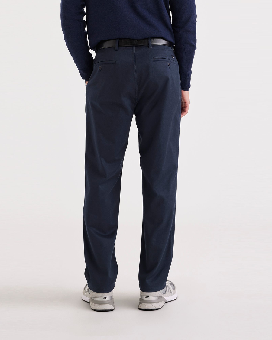 Back view of model wearing Navy Blazer Men's Relaxed Tapered Fit Original Chino Pants.