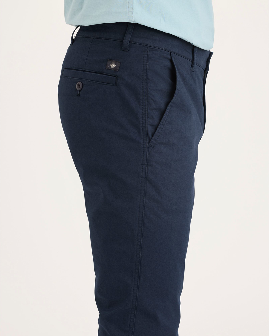 Side view of model wearing Navy Blazer Men's Skinny Fit Original Chino Pants.