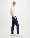 Side view of model wearing Navy Blazer Men's Slim Tapered Fit Cargo Pants.