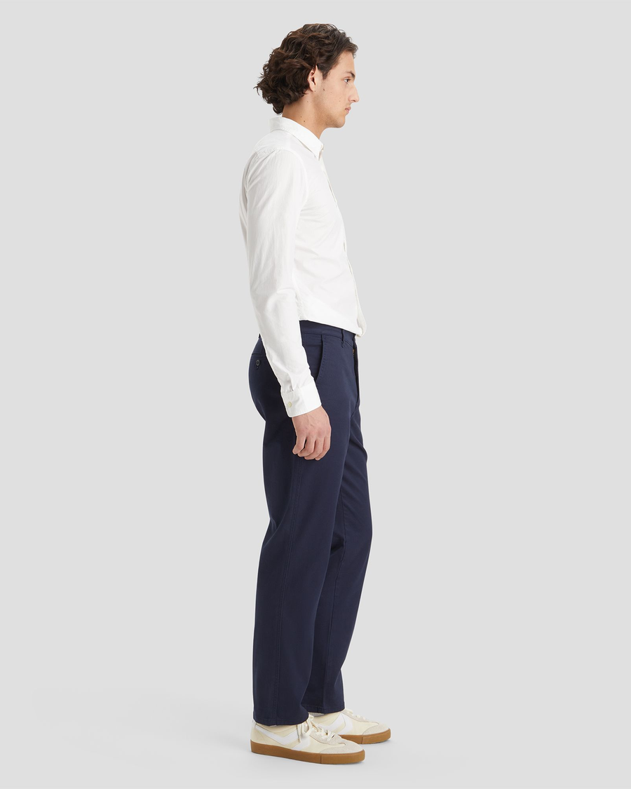 Side view of model wearing Navy Blazer Men's Straight Fit Original Chino Pants.