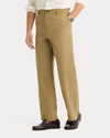 Side view of model wearing New British Khaki Eighty-Six Original Chino Pants, Loose Fit.