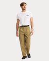 View of model wearing New British Khaki Eighty-Six Original Pleated Chinos, Loose Fit.