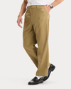 Side view of model wearing New British Khaki Eighty-Six Original Pleated Chinos, Loose Fit.